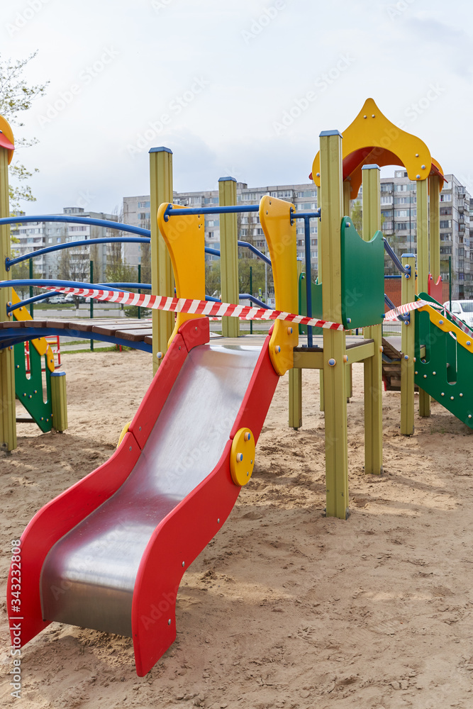 A closed playground for children with tape during the COVID-19 pandemic, Coronavirus. A closed playground for children with tape during the COVID-19 pandemic, Coronavirus.