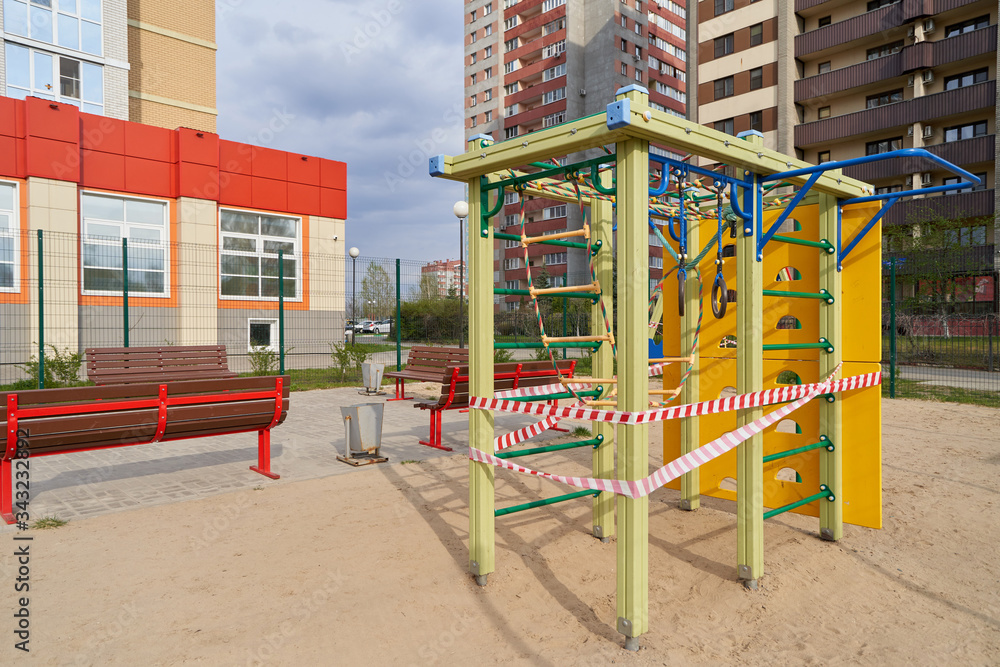 A closed playground for children with tape during the COVID-19 pandemic, Coronavirus. A closed playground for children with tape during the COVID-19 pandemic, Coronavirus.