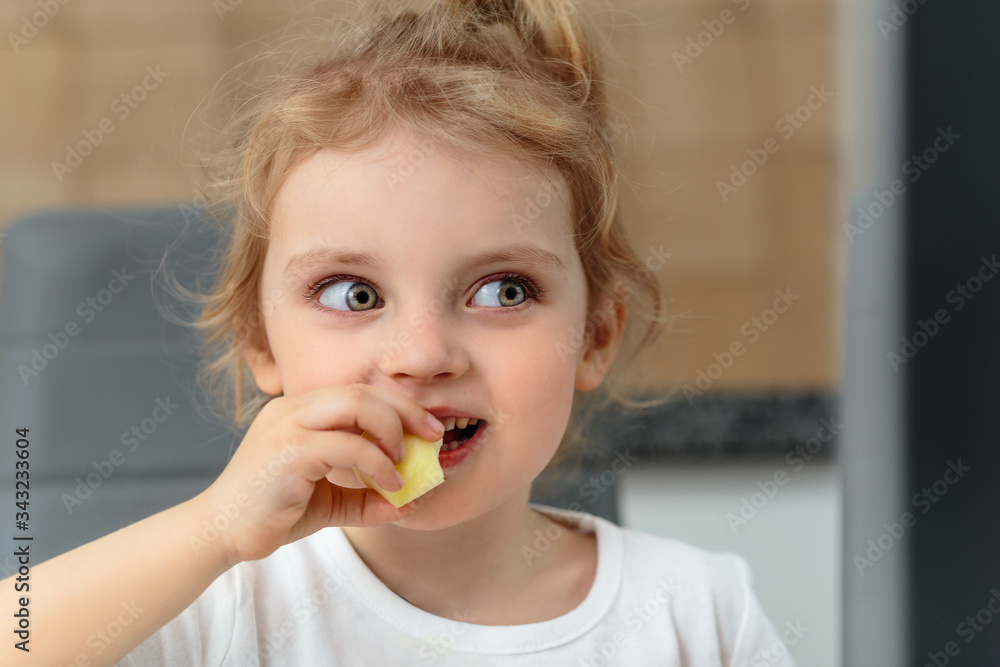 Сute little girl eating an apple. Smiling. Close up Сute little girl eating an apple. Smiling. Close up