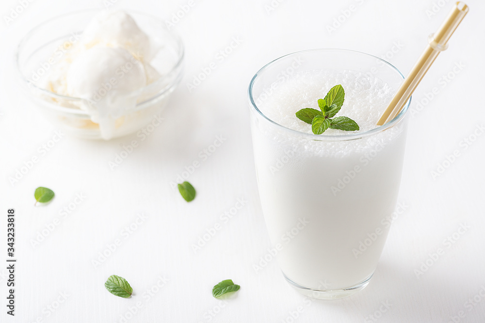 Vanilla Shake with Ice Cream and Mint on white background. Vanilla Ice Cream Milk Shake. Banana Smoothie with Mint and Vanilla. Vanilla Shake with Ice Cream and Mint on white background. Vanilla Ice Cream Milk Shake. Banana Smoothie with Mint and Vanilla.