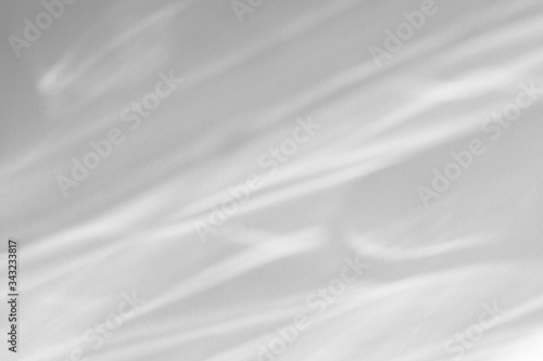 Blurred water texture overlay effect for photo and mockups. Organic drop diagonal shadow and light caustic effect on a white wall. Shadows for natural light effects © Aleksandra Konoplya