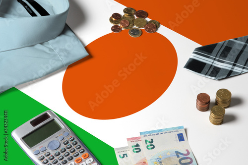 Wallpaper Mural Niger flag on minimal money concept table. Coins and financial objects on flag surface. National economy theme. Torontodigital.ca