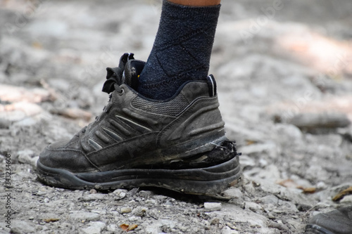 detached sole on the tourist's sneakers. They broke their boots in the woods.