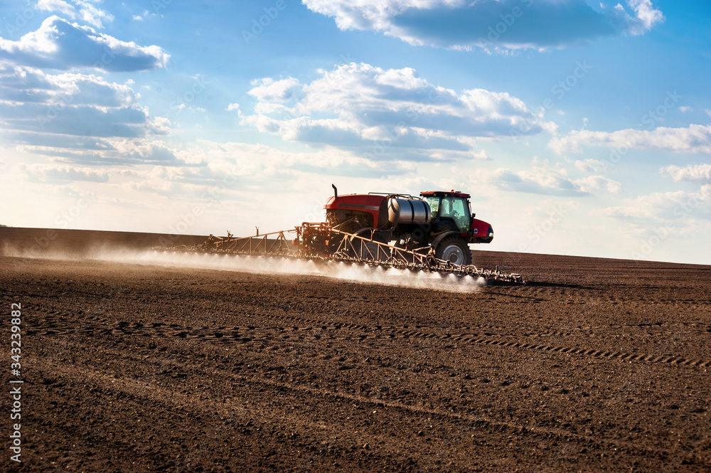 Fototapeta premium self-propelled sprayer in the field makes fertilizers in early spring