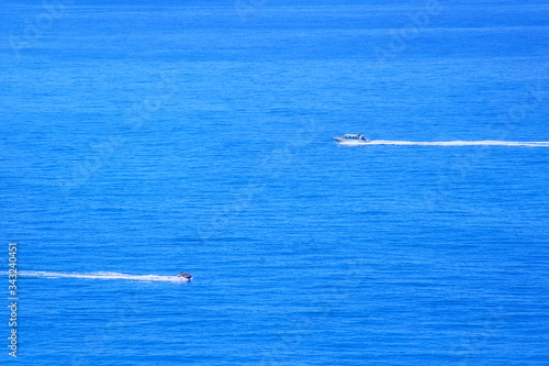 Motor boats race on the blue sea in summer. Holidays, travel, relaxation.