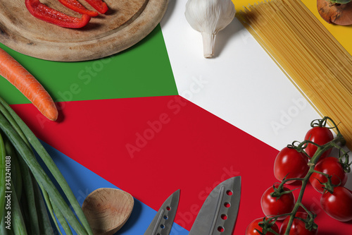Comoros flag on fresh vegetables and knife concept wooden table. Cooking concept with preparing background theme.