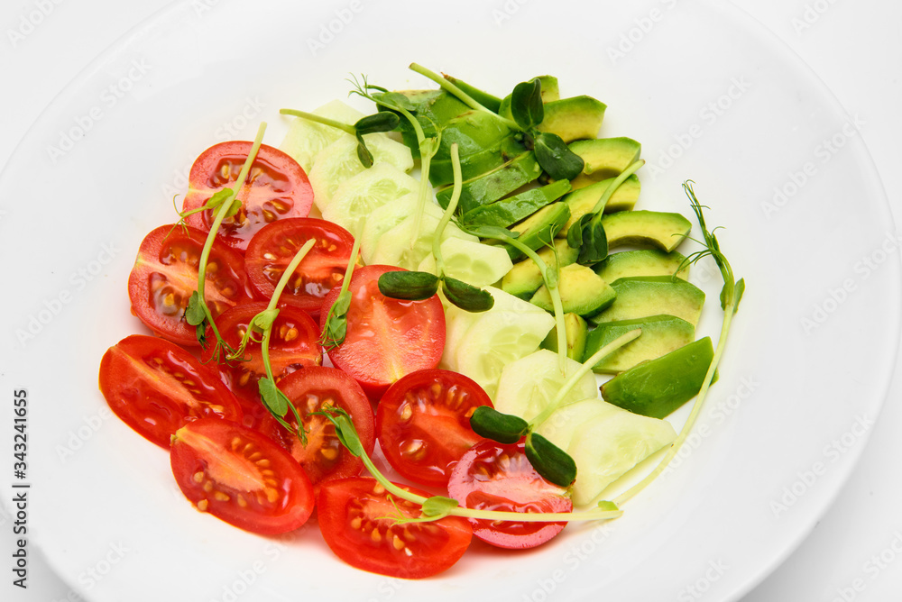 top view mix fresh vegetable diet salad with tomatoes cucumbers avocado on white dish top view mix fresh vegetable diet salad with tomatoes cucumbers avocado on white dish