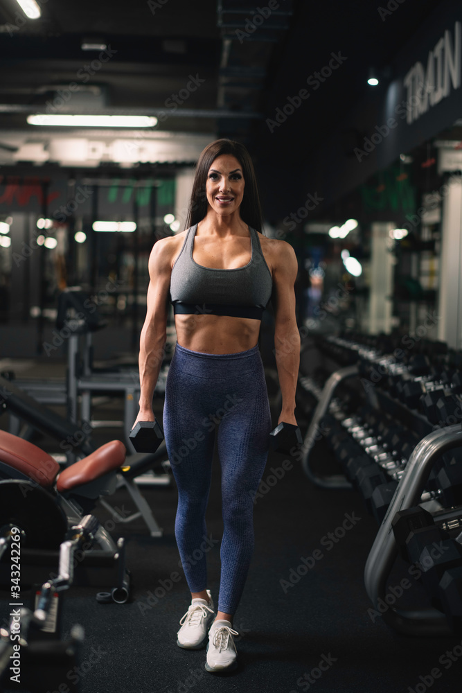 Fototapeta premium Fitness woman on training. Young woman in the gym. 