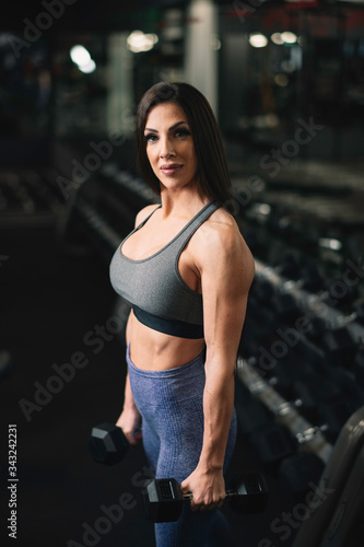 Fitness woman on training. Young woman in the gym. 