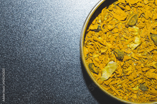 Curry spice in the jar. curcuma seasoning. yellow condiment. copy space