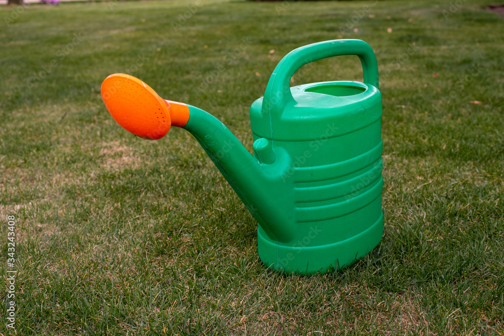 green watering can with orange tip green watering can with orange tip