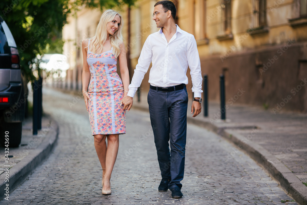 woman with her husband walking around the city, dressed neatly