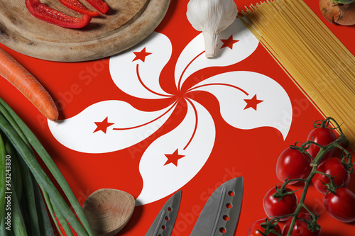 Hong Kong flag on fresh vegetables and knife concept wooden table. Cooking concept with preparing background theme.
