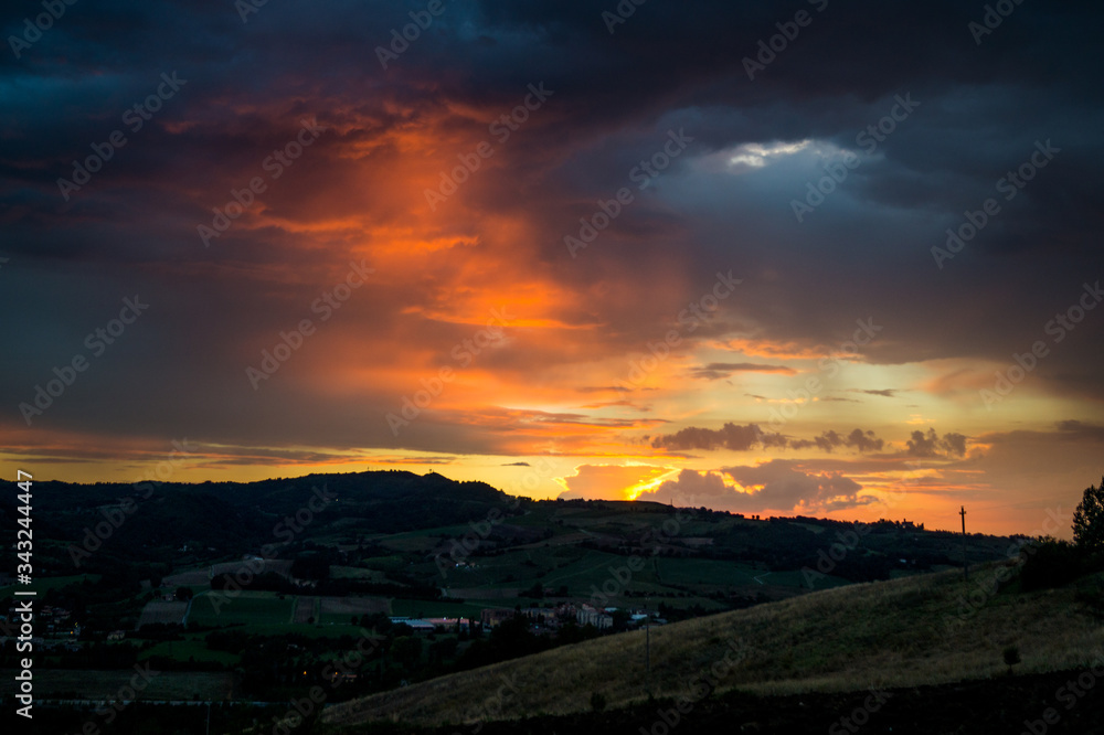Fototapeta premium Sunset over the city hills of Bologna, Italy, after a strorm