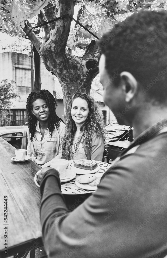 Coffee and biscuits for two young women served by black waiter Coffee and biscuits for two young women served by black waiter