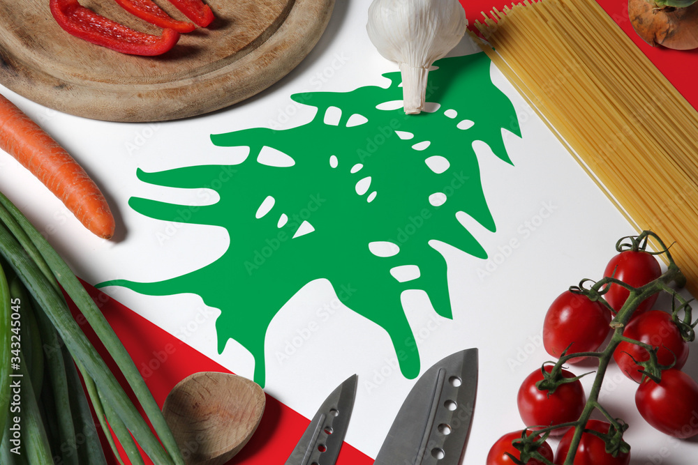 Fototapeta premium Lebanon flag on fresh vegetables and knife concept wooden table. Cooking concept with preparing background theme.