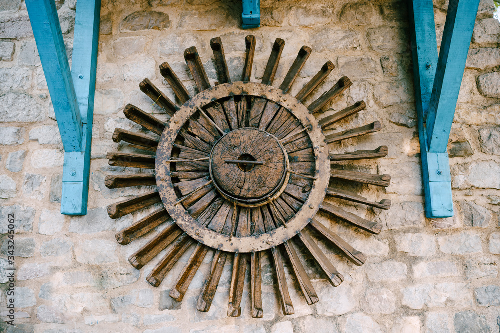 The wheel of a water mill. The old wooden wheel of the water mill is