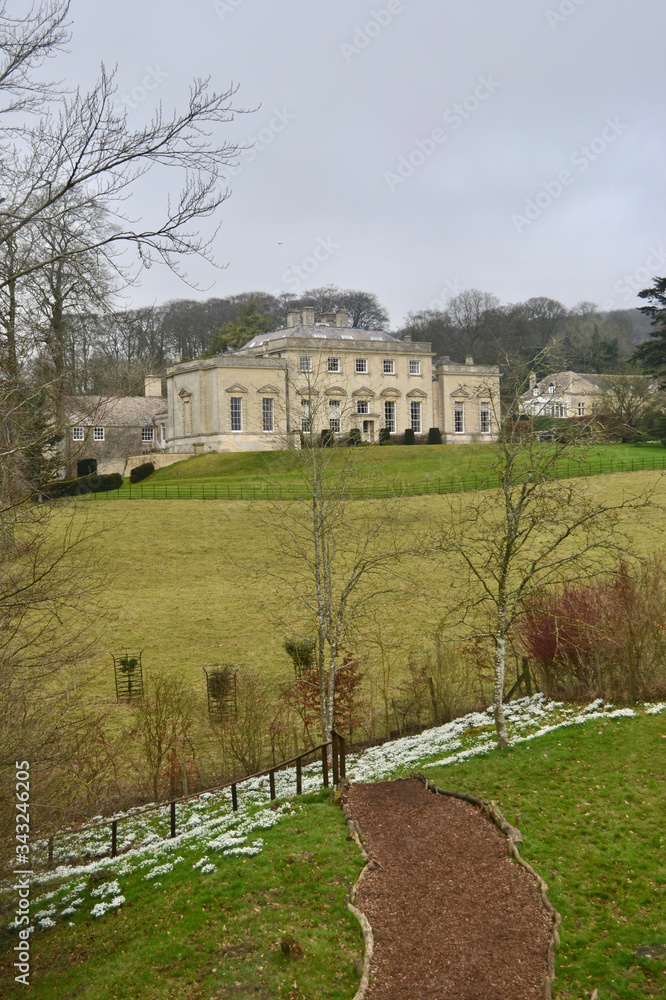 A traditional English 18th century manor house above a footpath in winter