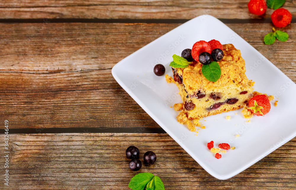 Piece of blueberry pie on white plate on wooden background. Piece of blueberry pie on white plate on wooden background.