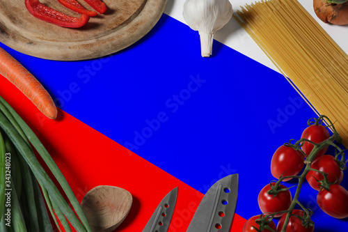Russia flag on fresh vegetables and knife concept wooden table. Cooking concept with preparing background theme.