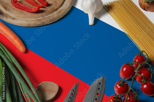 Slovenia flag on fresh vegetables and knife concept wooden table. Cooking concept with preparing background theme.