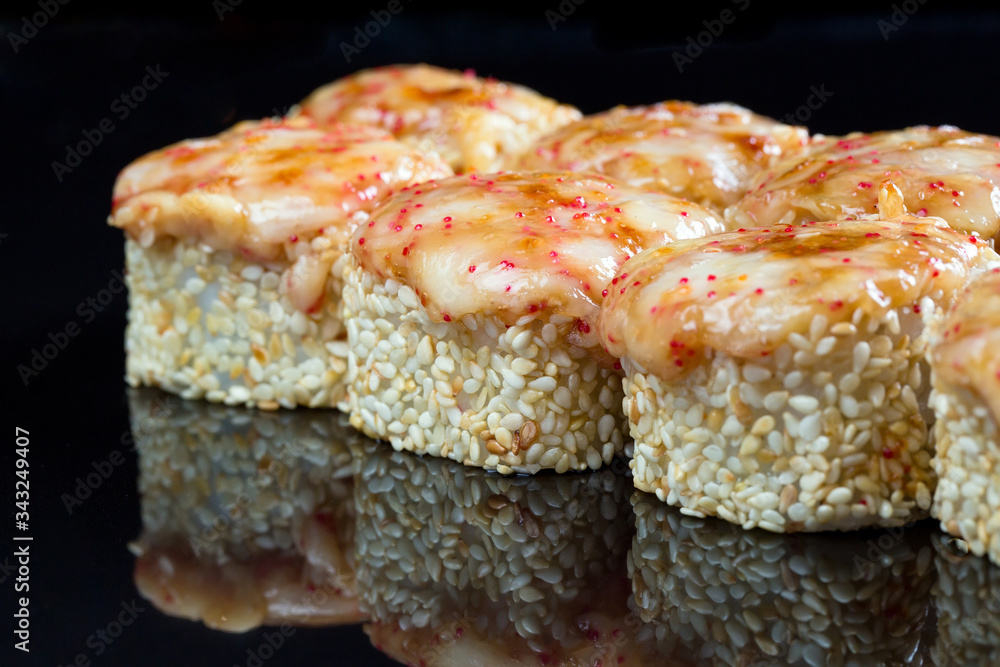 Sushi rolls with squid, mussel and cheese on a black background. Sushi rolls with squid, mussel and cheese on a black background.