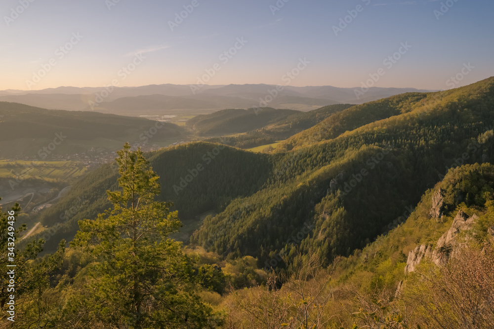 View of the countryside under the mountains at sunset.