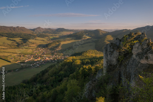 View of the countryside under the mountains at sunset.