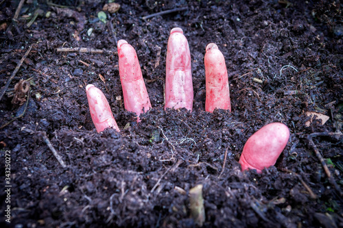 hand of murdered woman buried under the ground photo