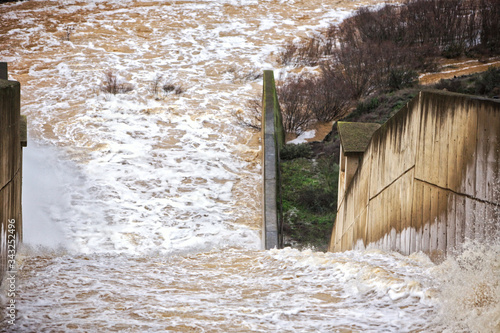 Reservoir Jándula, expelling water after several months of rain, Jaen, Spain photo