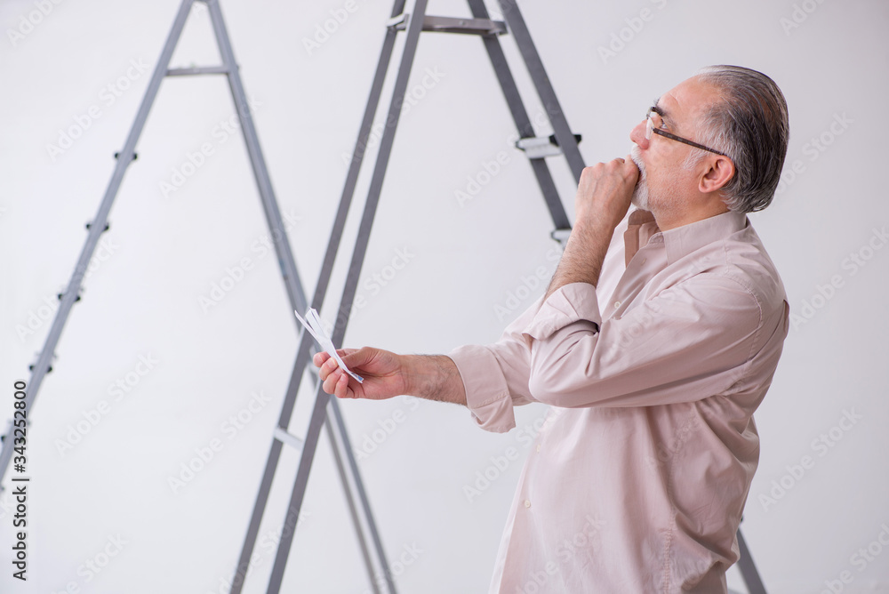 Old husband contractor in home renovation concept Old husband contractor in home renovation concept