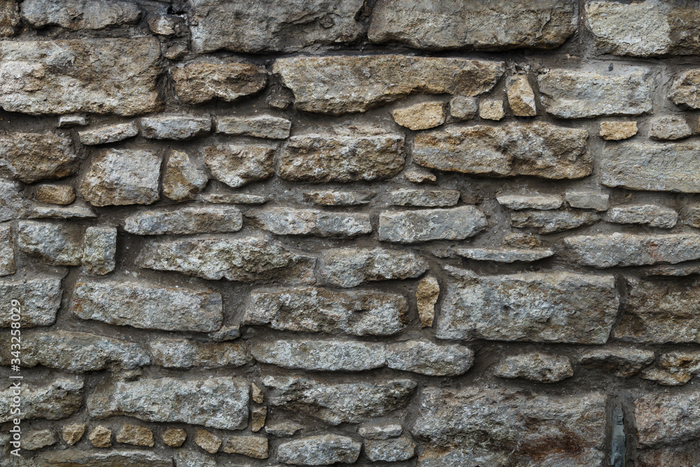Cobblestone texture.Marble and granite drainage system closeup.Concrete wall with gravel. Gray foundation of the house. Cobblestone texture.Marble and granite drainage system closeup.Concrete wall with gravel. Gray foundation of the house.