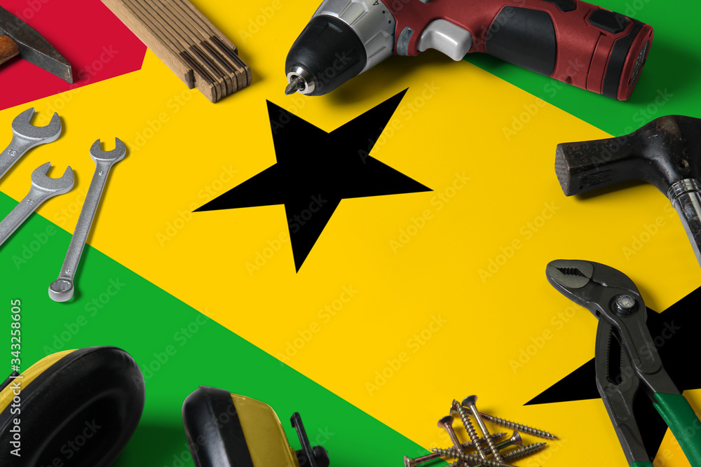 Sao Tome And Principe flag on repair tool concept wooden table background. Mechanical service theme with national objects.