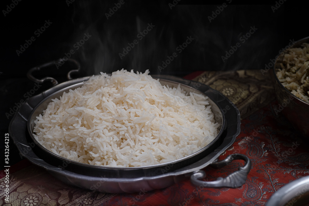 Steaming cooked basmati rice on metal plate