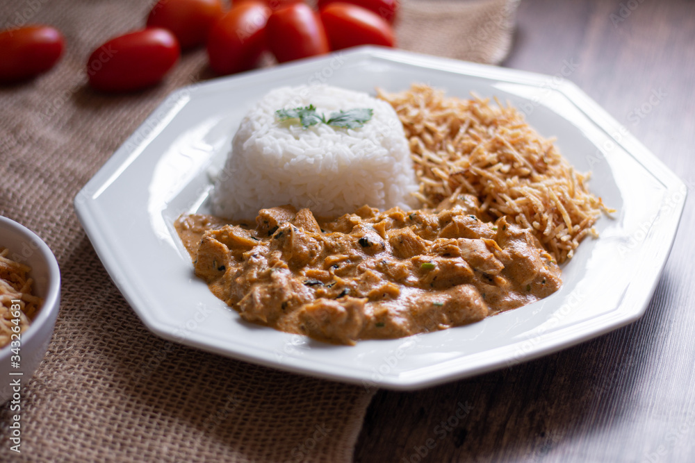 Food plate with meat stroganoff with rice and french fries. Wood background. Food plate with meat stroganoff with rice and french fries. Wood background.