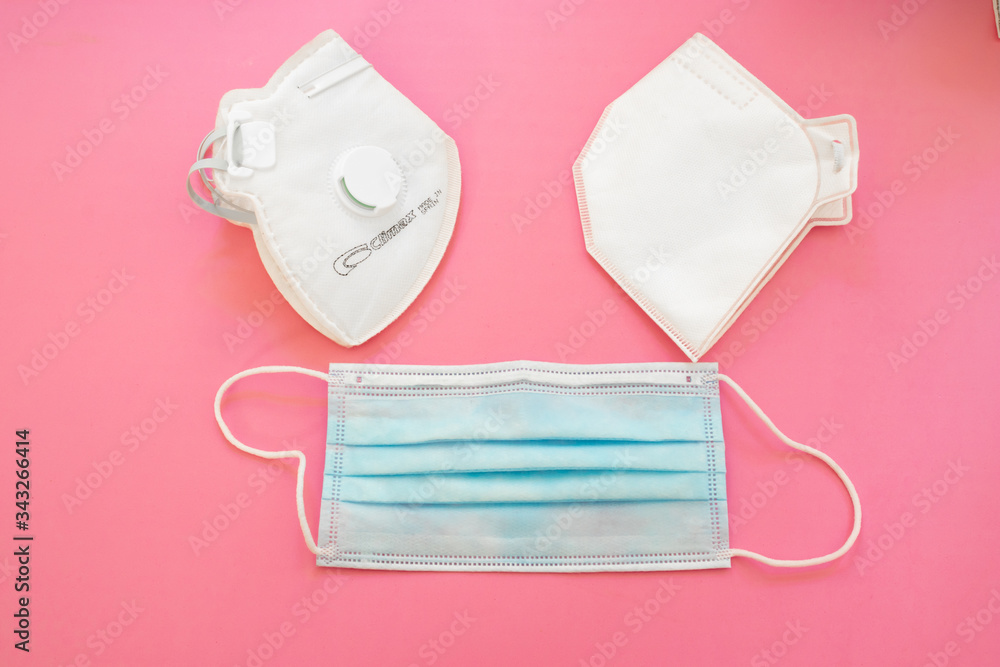 Surgical mask with rubber ear straps. Typical 3-ply surgical mask, masks pff2 and pff3 against covid. Procedure mask from bacteria. Protection concept. Surgical mask with rubber ear straps. Typical 3-ply surgical mask, masks pff2 and pff3 against covid. Procedure mask from bacteria. Protection concept.