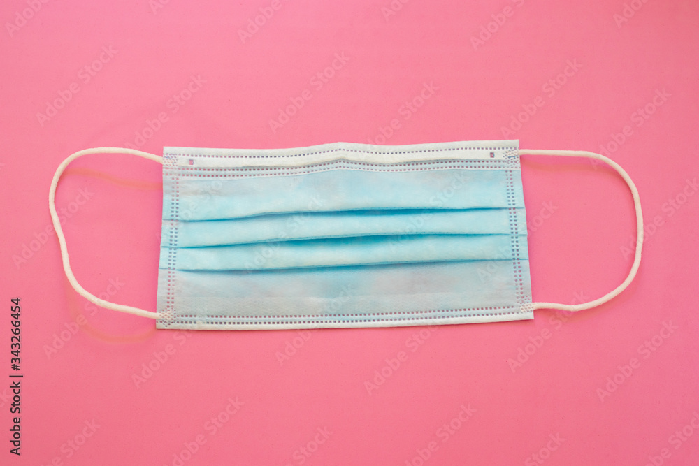 Surgical mask with rubber ear straps. Typical 3-ply surgical mask, masks pff2 and pff3 against covid. Procedure mask from bacteria. Protection concept. Surgical mask with rubber ear straps. Typical 3-ply surgical mask, masks pff2 and pff3 against covid. Procedure mask from bacteria. Protection concept.