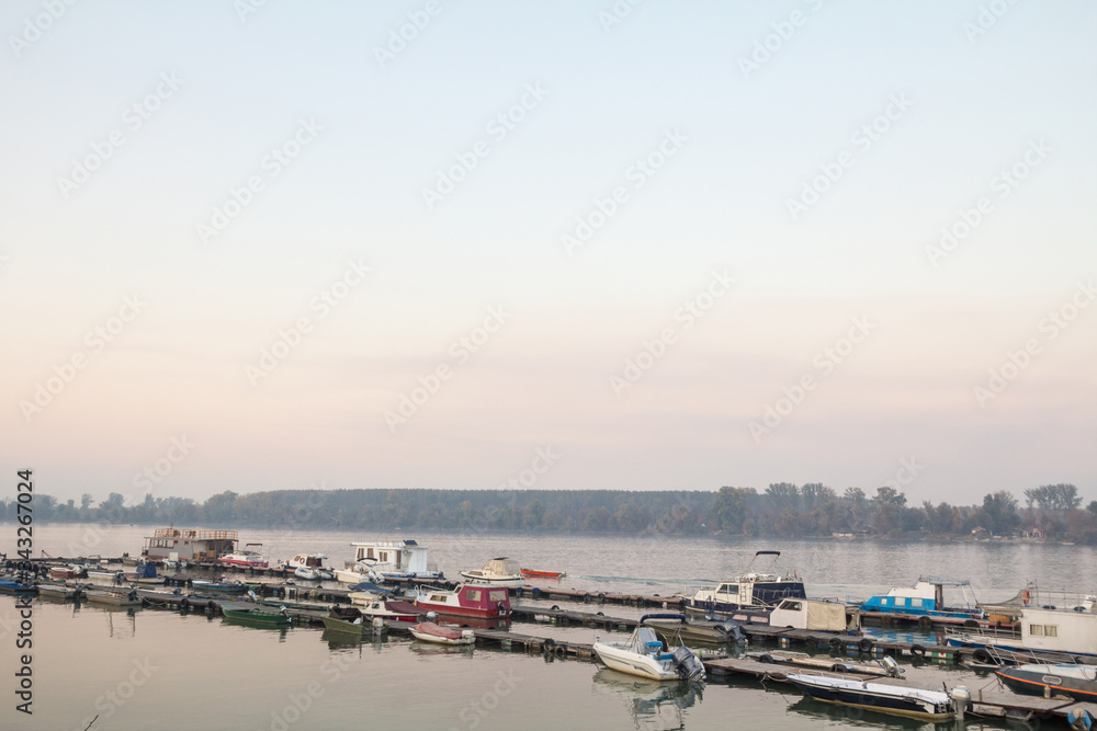 Boats anchored on the port and harbour of Zemun, on the typical pontoon of the Zemunski marina, in belgrade, Serbia, one of the main navigation hubs on the Danube river.
