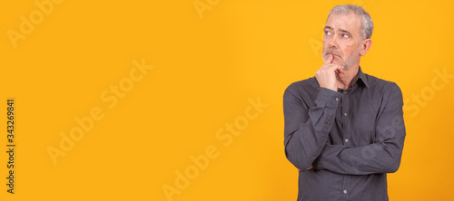 isolated adult or senior man with thoughtful expression
