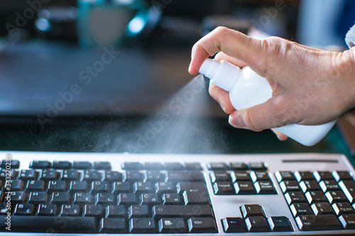 Canvas Print sterilizing computer keyboard with alcohol liquid