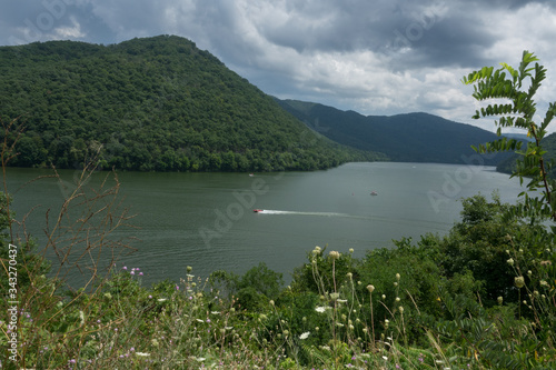 I captured this image at Bluestone Lake near Hinton, West Virginia. This was a very gloomy day, and a boater is seen going across the lake.