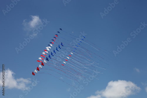 THREE KITES WITH TAIL IN THE WIND, RED, WHITE, BLUE