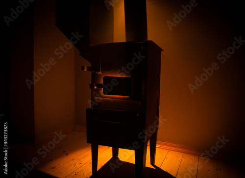 Fire burning in small black iron stove. Closeup photo with selective focus