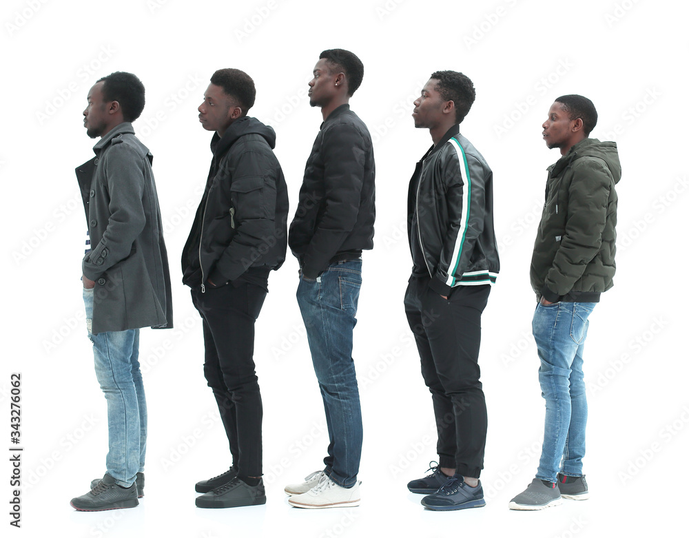 Obraz premium group of diverse guys standing in turns . isolated on white