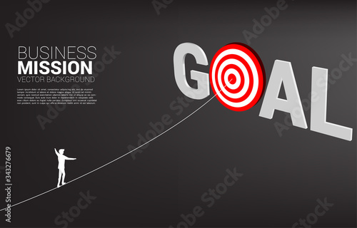 silhouette of businessman walk rope to center of target. Concept of targeting and Business challenge.