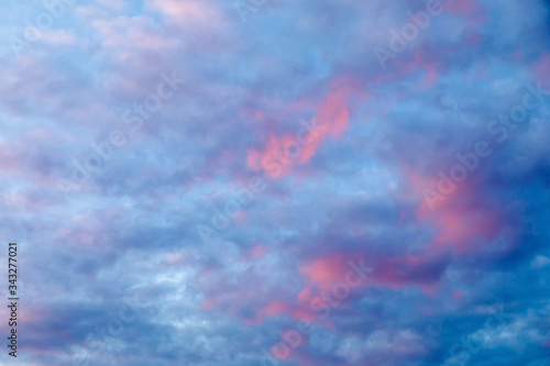 Dramatic blue sky with pink clouds at sunset.