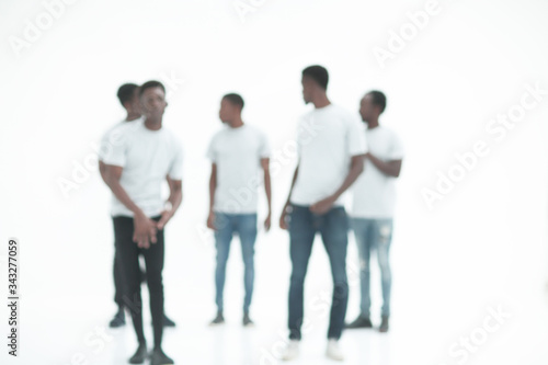 blurry image of a group of young men in white t-shirts