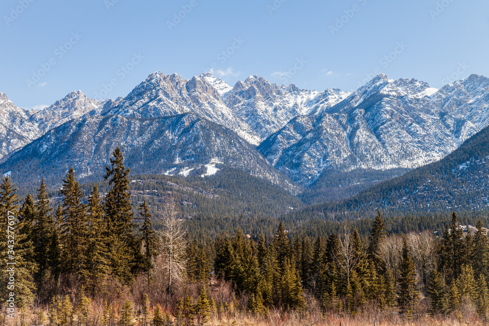 high rocky mountains peak in snow blue sky.