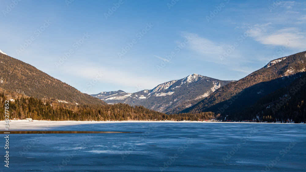 Frozen and snow covered Three Valley Lake british columbia clouds on sky.