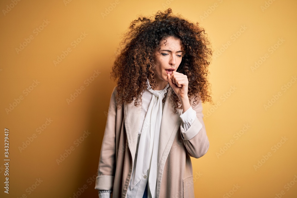 Young beautiful brunette woman with curly hair and piercing wearing casual t-shirt and diadem feeling unwell and coughing as symptom for cold or bronchitis. Health care concept.